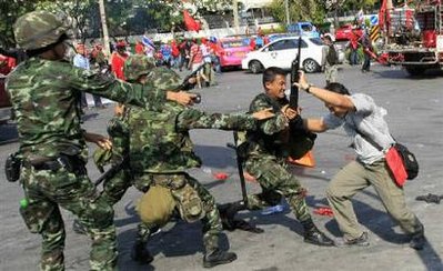 ဆႏၵျပသူ တစ္ဦးက ပစ္ခတ္ရန္ လာသည့္ ထိုင္းစစ္သား တစ္ဦး လက္ထဲမွ ေသနတ္ ကိုဆြဲလုေန ပံု